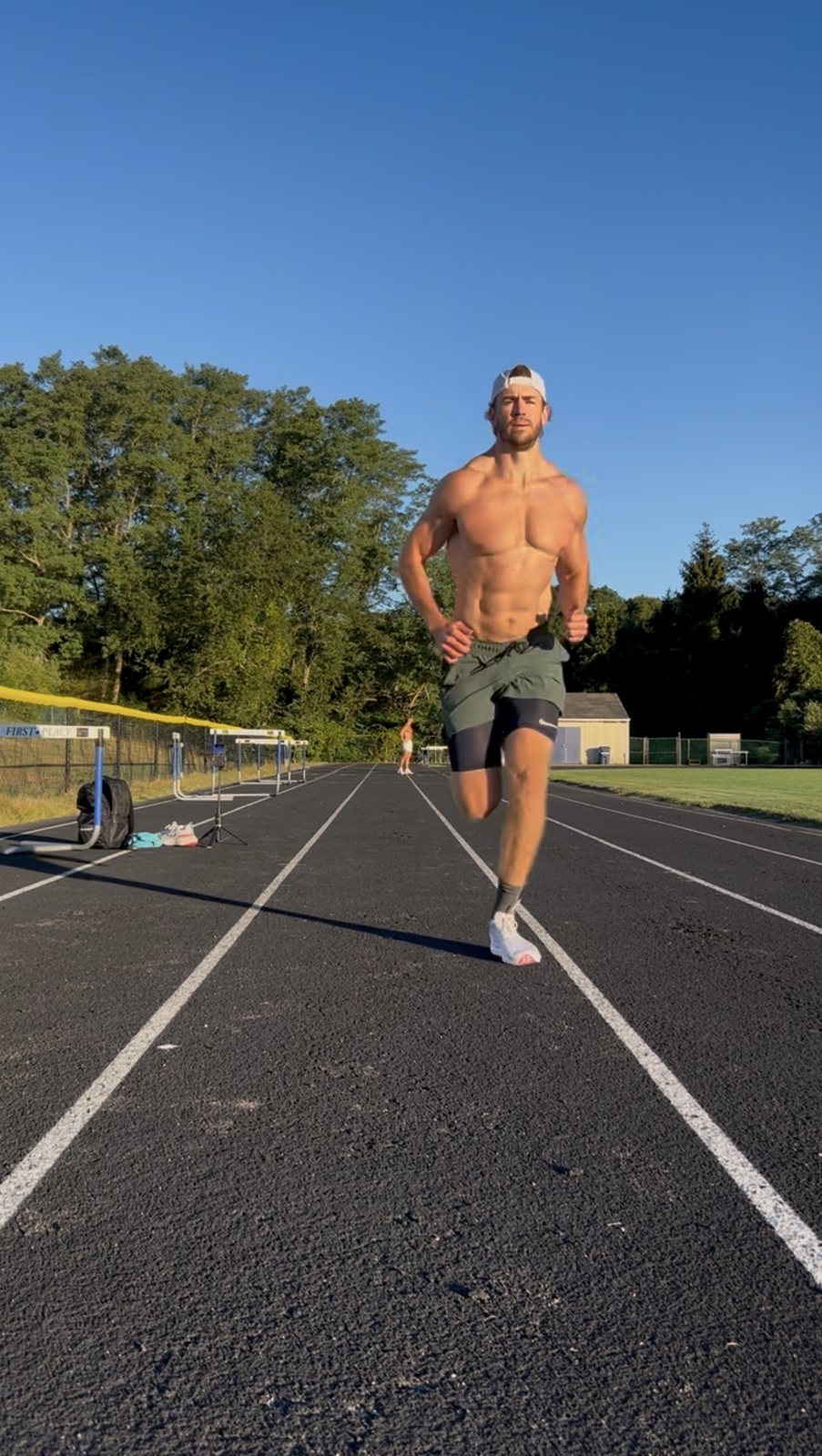 McKinley Slade running toward the camera on an outdoor track under a clear sky